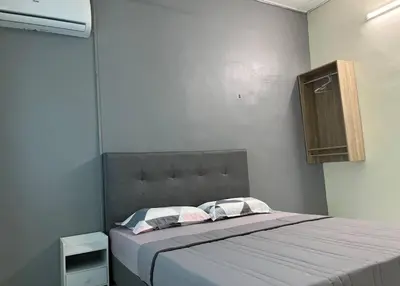 a bed with two pillows and a headboard in a room at Homestay Malim Nawar in Malim Nawar