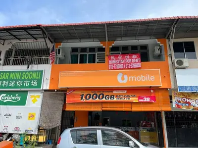 a car parked in front of a building with signs at Homestay Malim Nawar in Malim Nawar