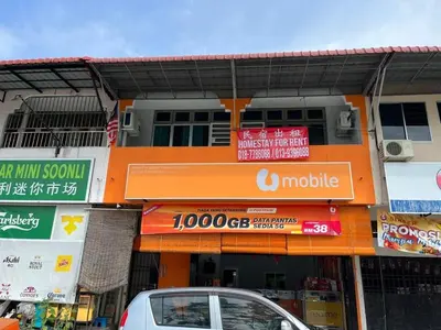 an orange building with signs on the side of it at Homestay Malim Nawar in Malim Nawar