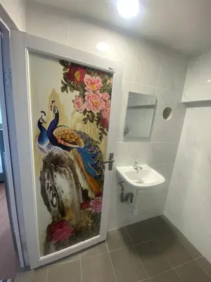 a bathroom with a painting on the wall next to a sink at 6 PAX 1 BEDROOM SOHO near SPICE ARENA PANTAI SPECIALIST AIRPORT in Bayan Lepas