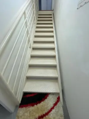 a stairwell with a rug on the floor at 6 PAX 1 BEDROOM SOHO near SPICE ARENA PANTAI SPECIALIST AIRPORT in Bayan Lepas