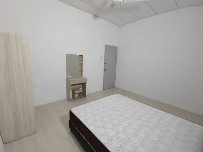 a white room with a bed and a dresser in it at GP Hostel Penang in George Town