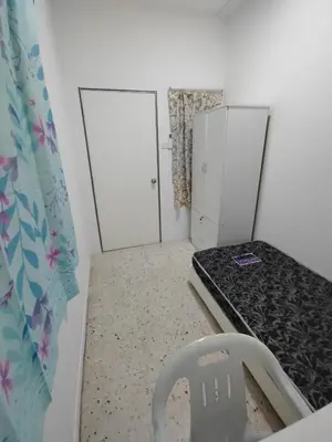 a room with a bed and two white doors at GP Hostel Penang in George Town