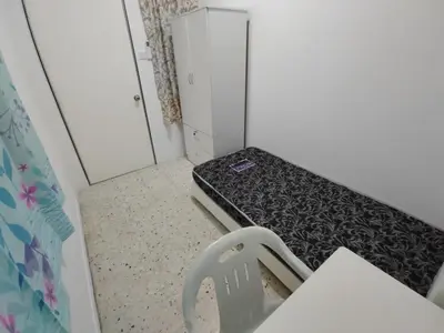 a small room with a bed in a room at GP Hostel Penang in George Town
