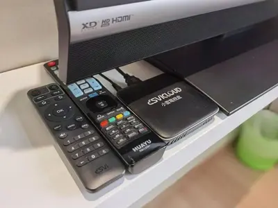 a remote control and other electronics sitting on a computer monitor at The Regency Luxury Suite -Gurney Strait Quay in Tanjong Tokong
