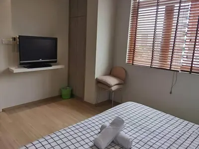 a bedroom with a bed and a tv and a chair at The Regency Luxury Suite -Gurney Strait Quay in Tanjong Tokong