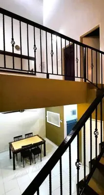 a room with a table and a staircase with a table and benches at Grand Homestay Kulim 4-Bedroom in Lunas