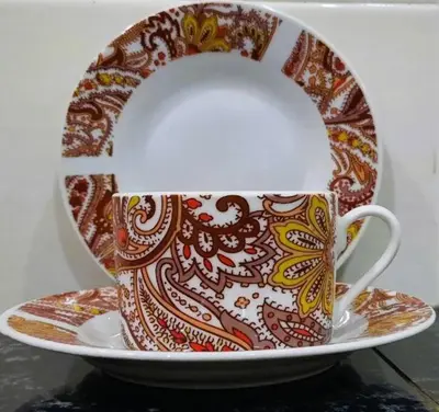 a coffee cup on a plate on a table at Grand Homestay Kulim 4-Bedroom in Lunas