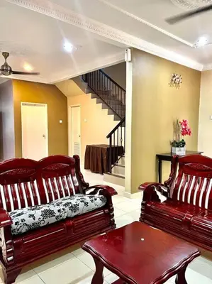a living room with two red benches and a staircase at Grand Homestay Kulim 4-Bedroom in Lunas