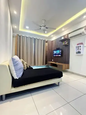 a bedroom with a bed and a tv in it at The Majestic Ipoh Town by 178homestay in Ipoh