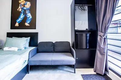 a small bedroom with a bed and a chair at CITY HUNTER At Georgetown in George Town
