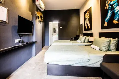 a bedroom with two beds and a flat screen tv at CITY HUNTER At Georgetown in George Town