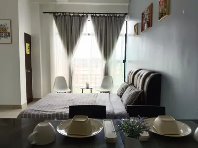a bedroom with a bed and a large window at Armada Sweet Homestay in Gua Musang
