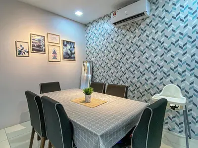 a dining room with a table and chairs at PoolView Waterpark 300Mbps Ipoh Homestay Manhattan Condo 4-7pax 3bedroom Station 18 pengkalan in Ipoh