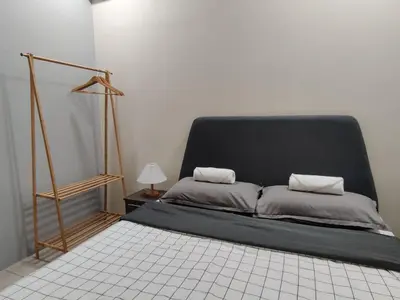 a bed with a black headboard in a room at PoolView Waterpark 300Mbps Ipoh Homestay Manhattan Condo 4-7pax 3bedroom Station 18 pengkalan in Ipoh