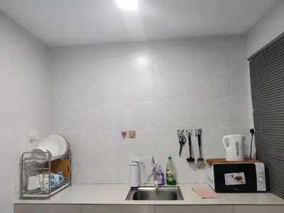 a kitchen counter with a sink and a microwave at PoolView Waterpark 300Mbps Ipoh Homestay Manhattan Condo 4-7pax 3bedroom Station 18 pengkalan in Ipoh