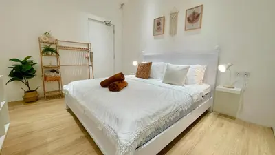 a bedroom with a white bed with a teddy bear on it at Helena’s Studio Suite Gerik in Gerik