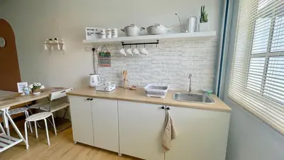 a kitchen with a sink and a brick wall at Helena’s Studio Suite Gerik in Gerik