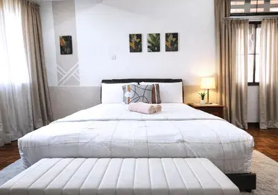 a bedroom with a large bed with a white bedspread at Advent Villa, just 80 meters to Penang Adventist Hospital in George Town