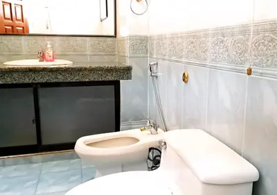 a bathroom with a white toilet and a sink at Advent Villa, just 80 meters to Penang Adventist Hospital in George Town