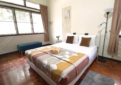 a bedroom with a large bed in a room at Advent Villa, just 80 meters to Penang Adventist Hospital in George Town