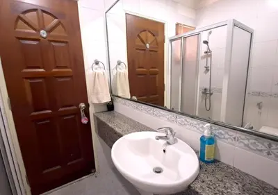 a bathroom with a sink and a mirror at Advent Villa, just 80 meters to Penang Adventist Hospital in George Town