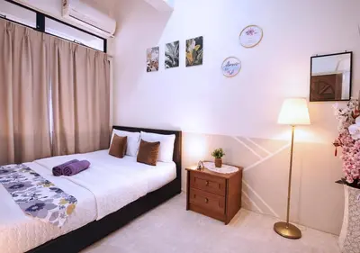 a bedroom with a bed and a lamp and a window at Advent Villa, just 80 meters to Penang Adventist Hospital in George Town