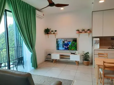 a living room with a flat screen tv on a wall at Sunway Onsen Studio @ Lost World of Tambun in Ipoh