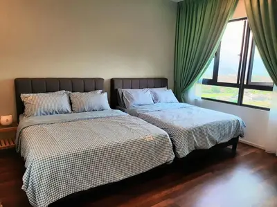 two beds sitting next to each other in a bedroom at Sunway Onsen Studio @ Lost World of Tambun in Ipoh