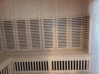 a wooden bench in a room with a white wall at Sunway Onsen Theme Park View @Lost World of Tambun in Ipoh