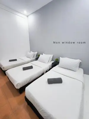 three beds in a room with the words mom window room at Gurney Coast Guest House by Sky Hive in George Town