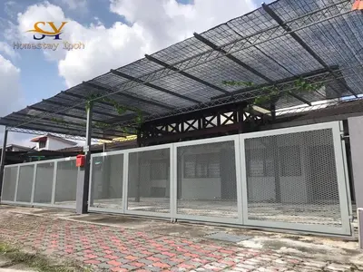 a building with a fence with a metal roof at Ipoh Family Homestay Masjid Muhammadiah Evicharger SY16 in Ipoh