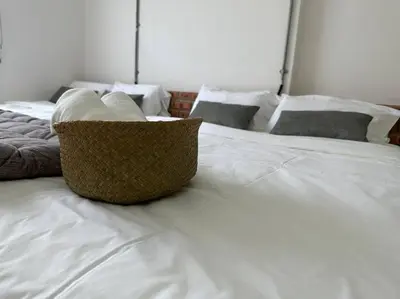 a white bed with white pillows on it at Ipoh Family Homestay Masjid Muhammadiah Evicharger SY16 in Ipoh
