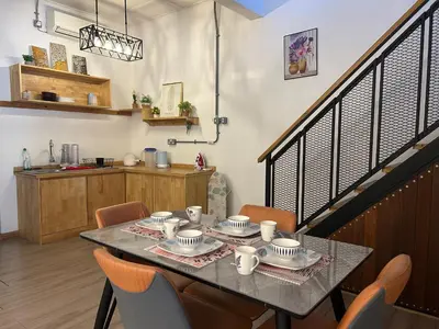 a dining room with a table and chairs at Ipoh Family Homestay Masjid Muhammadiah Evicharger SY16 in Ipoh