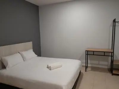 a bed with a roll of paper on top of it at The Great Hotel in Ipoh