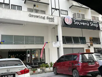 a red car parked in front of a store at Cozystay @ The Quintet, Cameron in Tanah Rata