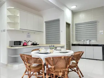 a kitchen with a table and chairs in a room at Cozystay @ The Quintet, Cameron in Tanah Rata