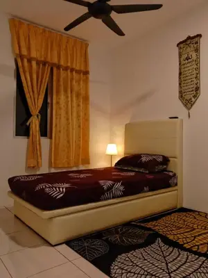 a bedroom with a bed and a ceiling fan at AWANA HOMESTAY in Sungai Petani