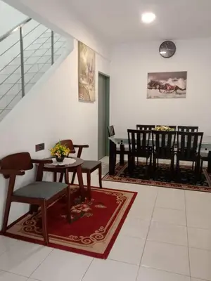 a living room with a table and chairs at AWANA HOMESTAY in Sungai Petani