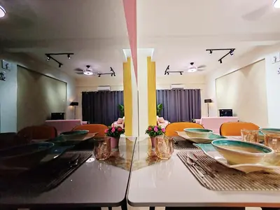 a dining room with a long table and chairs at Pavilionvillie M1T583 by irainbow in Kampong Kepayang