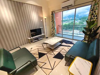a living room with chairs and a television and a balcony at Pavilionvillie M1T583 by irainbow in Kampong Kepayang