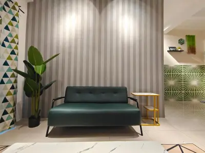 a green bench in a room with a plant at Pavilionvillie M1T583 by irainbow in Kampong Kepayang