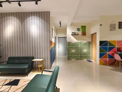 a lobby with green chairs and colorful walls at Pavilionvillie M1T583 by irainbow in Kampong Kepayang