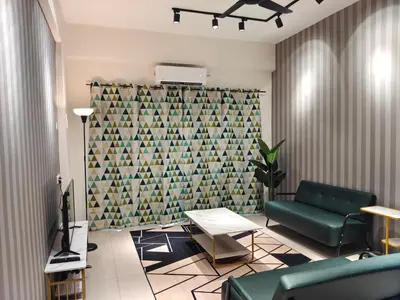 a living room with a green couch and a wall at Pavilionvillie M1T583 by irainbow in Kampong Kepayang