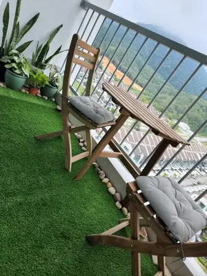 a chair and a bench on a balcony at NORDIC SKYHOME Ipoh in Kampong Ulu Chepor