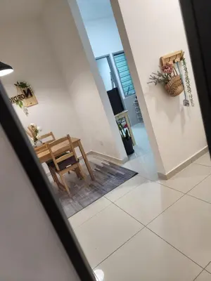 a view of a dining room and living room with a table at NORDIC SKYHOME Ipoh in Kampong Ulu Chepor