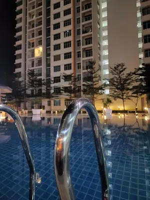 a swimming pool with two metal rails in front of buildings at NORDIC SKYHOME Ipoh in Kampong Ulu Chepor