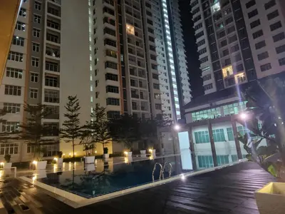 a pool in the middle of a city at night at NORDIC SKYHOME Ipoh in Kampong Ulu Chepor