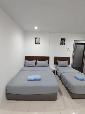 a bedroom with two beds with blue towels on them at 184 GURNEY DRIVE PENANG in George Town