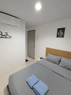 a bedroom with a bed with a blue towel on it at 184 GURNEY DRIVE PENANG in George Town
